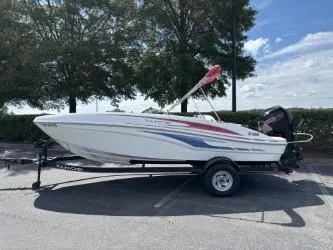 The Image of 2023 Tahoe T18 boat on trailer, parked outdoors under trees. - 1