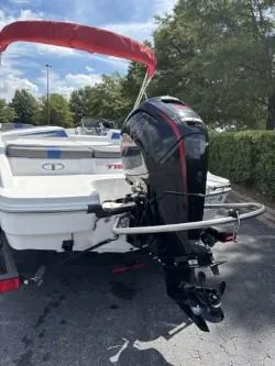 Slide: The Image of 2023 Tahoe T18 boat with outboard motor, parked outdoors. - 3