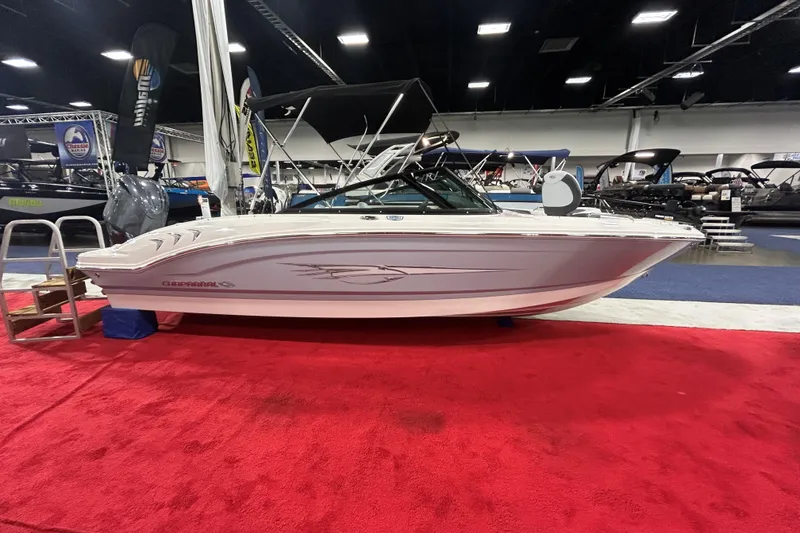 The Image of 2026 Chaparral 21 SSi Ski & Fish OB boat displayed on red carpet at indoor show. - 0