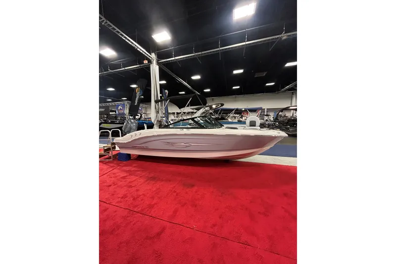 Slide: The Image of 2026 Chaparral 21 SSi Ski & Fish OB boat displayed indoors on red carpet. - 2