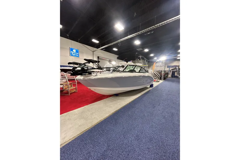 Slide: The Image of 2026 Chaparral 21 SSi Ski & Fish OB displayed at a boat show indoors. - 4