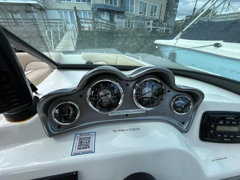 Slide: The Image of Dashboard of 2021 NauticStar 203DC Sport Deck boat with gauges and controls. - 14