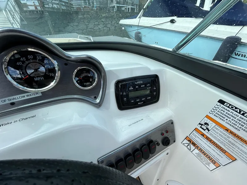 Slide: The Image of Dashboard of 2021 NauticStar 203DC Sport Deck boat with gauges and controls. - 15
