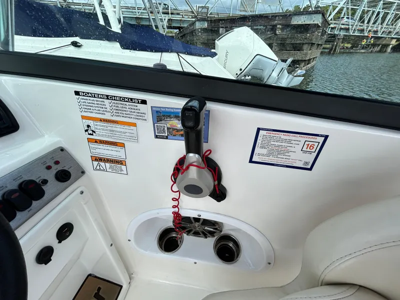 Slide: The Image of Interior view of 2021 NauticStar 203DC Sport Deck boat with control panel and safety checklist. - 16