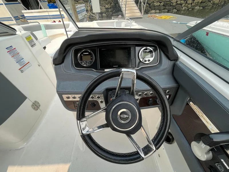Slide: The Image of 2021 NauticStar 203DC Sport Deck steering console with modern controls and sleek design. - 8