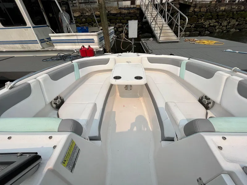 Slide: The Image of 2021 NauticStar 203DC Sport Deck boat interior with white seating and table. - 9