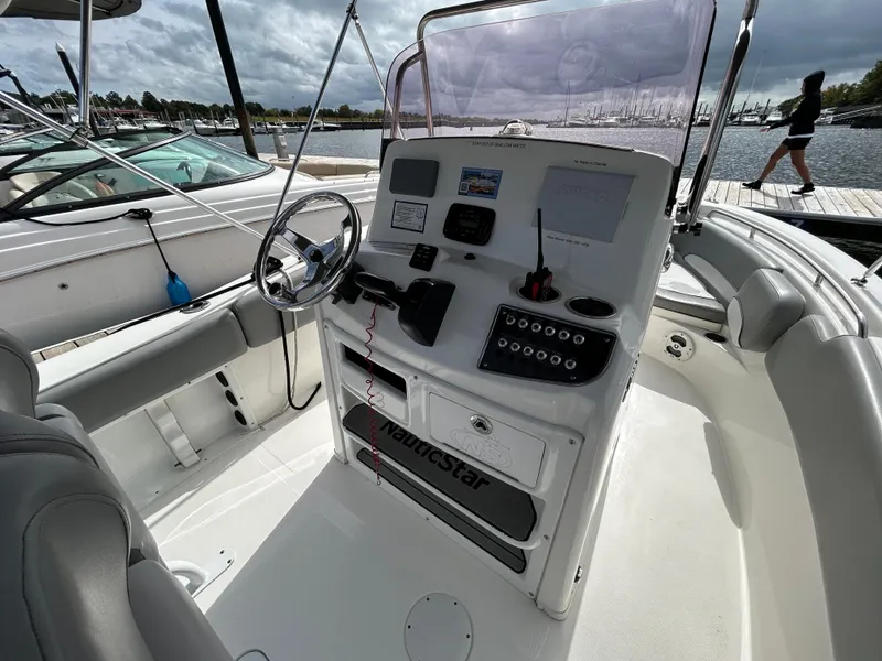 Slide: The Image of 2021 NauticStar 2102 Legacy boat interior with steering wheel and control panel. - 12