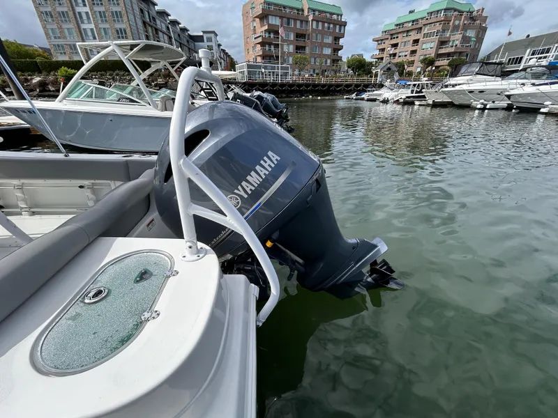Slide: The Image of 2021 NauticStar 2102 Legacy boat with Yamaha outboard engine docked in marina. - 4
