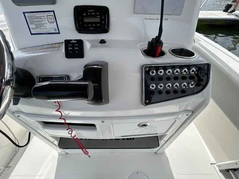 Slide: The Image of 2021 NauticStar 2102 Legacy boat console with controls and switches. - 9