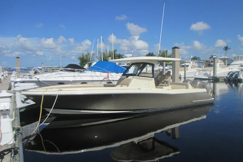 The Image of 2019 Chris-Craft Catalina 30 boat docked at a marina under a clear blue sky. - 0