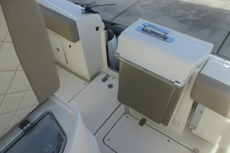 Slide: The Image of 2019 Chris-Craft Catalina 30 interior with beige seating and storage compartment. - 10