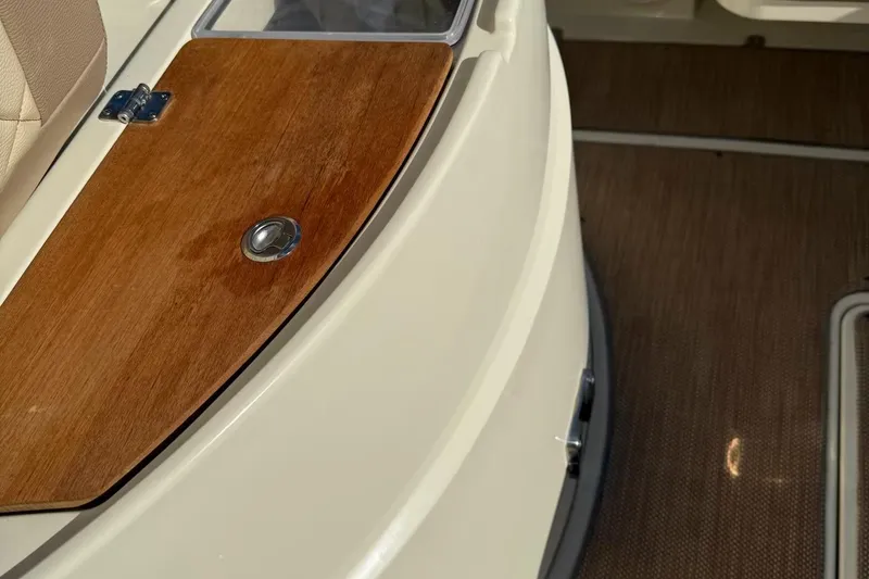 Slide: The Image of 2019 Chris-Craft Catalina 30 interior with wooden panel and beige seating. - 12