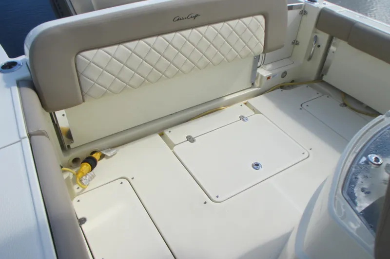 Slide: The Image of 2019 Chris-Craft Catalina 30 boat interior with cushioned seating and storage compartments. - 16