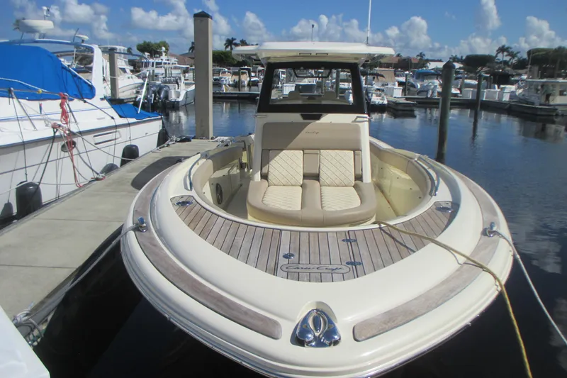 Slide: The Image of 2019 Chris-Craft Catalina 30 docked at marina, featuring elegant seating and sleek design. - 2