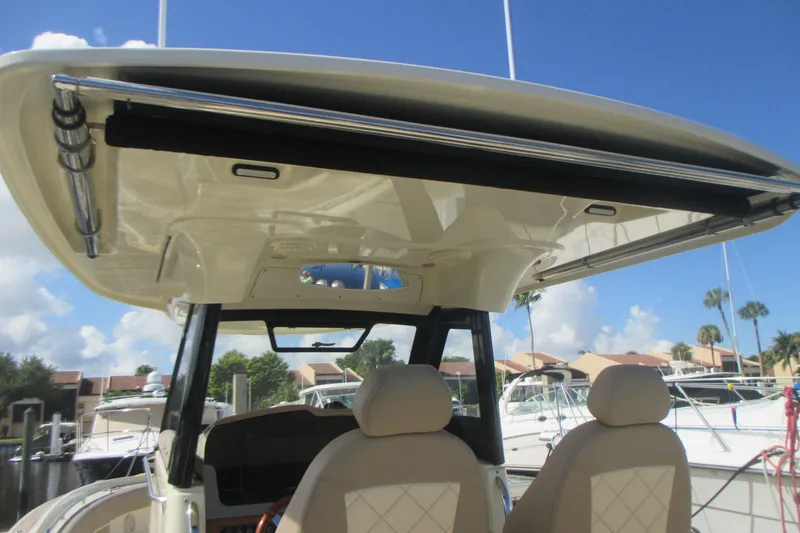 Slide: The Image of 2019 Chris-Craft Catalina 30 boat interior with helm seats and hardtop, docked at marina. - 20