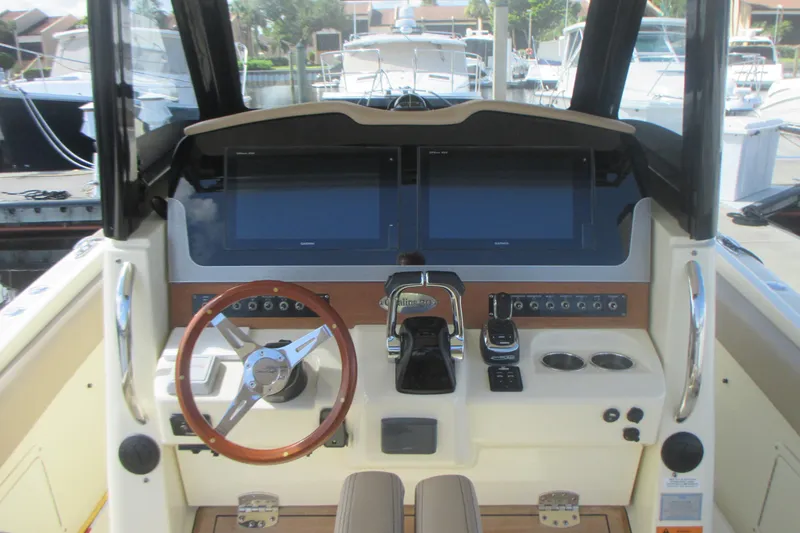Slide: The Image of 2019 Chris-Craft Catalina 30 helm with dual screens and wooden steering wheel. - 22