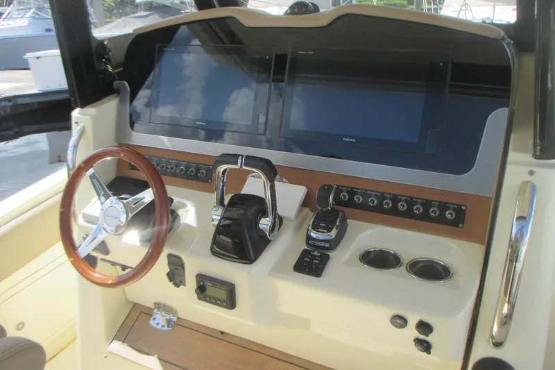 Slide: The Image of 2019 Chris-Craft Catalina 30 helm with dual screens, steering wheel, and controls. - 23