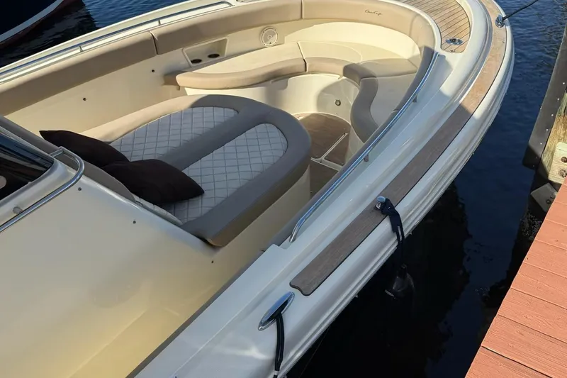 Slide: The Image of 2019 Chris-Craft Catalina 30 boat with elegant seating and wood accents docked by the water. - 28