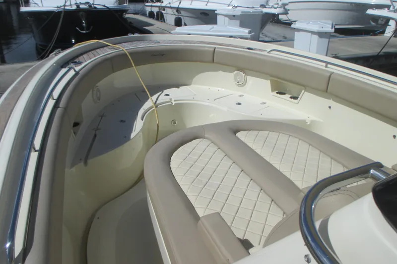 Slide: The Image of 2019 Chris-Craft Catalina 30 boat interior with beige seating and deck details. - 30