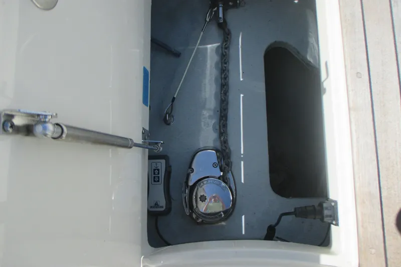 Slide: The Image of Anchor compartment of 2019 Chris-Craft Catalina 30 boat, featuring chain and winch. - 33