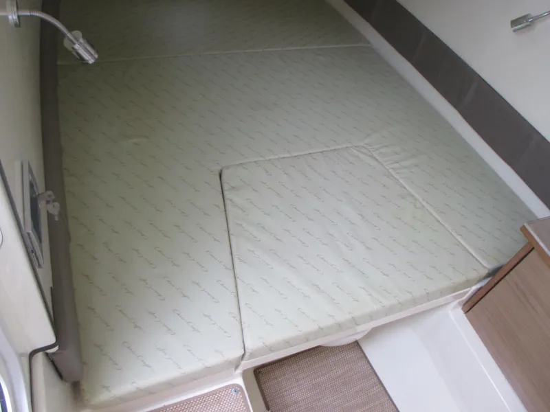 Slide: The Image of 2019 Chris-Craft Catalina 30 cabin interior with cushioned sleeping area. - 39