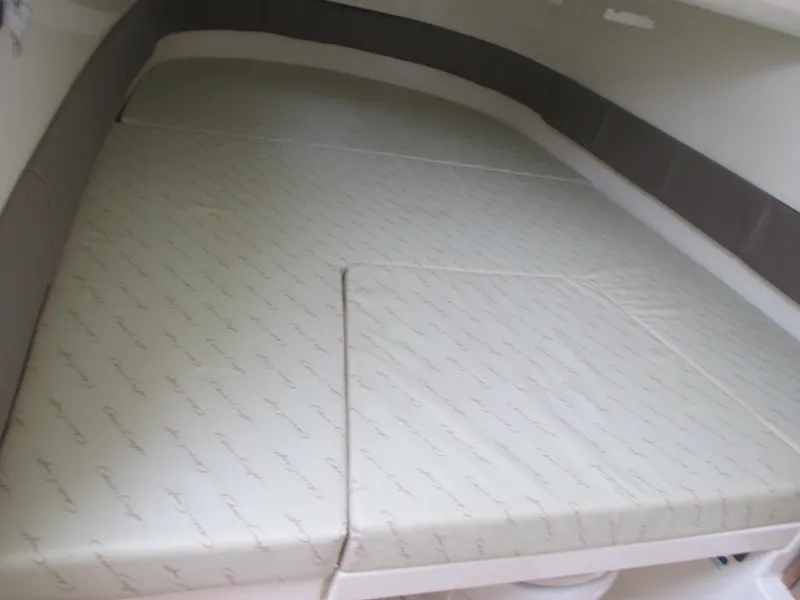 Slide: The Image of 2019 Chris-Craft Catalina 30 cabin interior with cushioned sleeping area. - 40