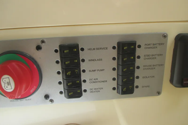 Slide: The Image of Control panel of a 2019 Chris-Craft Catalina 30 boat with various switches and battery controls. - 43
