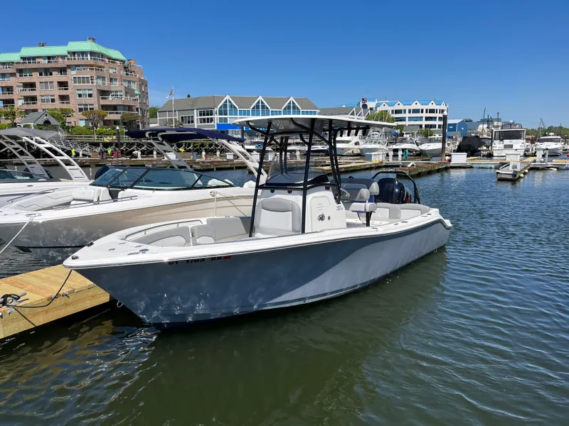 The Image of 2021 NauticStar 2302 Legacy boat on calm water under a blue sky. - 0