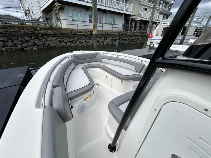 Slide: The Image of 2021 NauticStar 2302 Legacy with Yamaha outboard motor on a calm lake. - 15