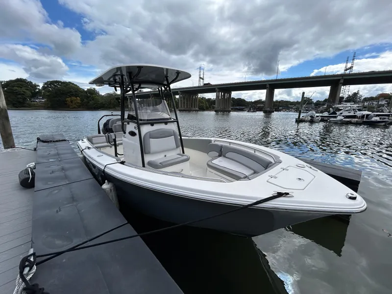 Slide: The Image of 2021 NauticStar 2302 Legacy boat on calm water under cloudy sky. - 3