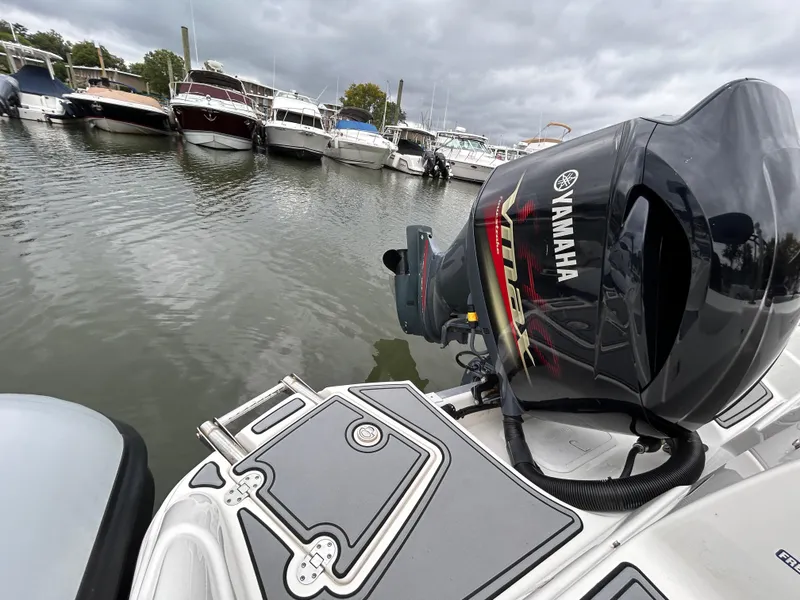 Slide: The Image of NauticStar 243 DC boat with Yamaha outboard motor docked in marina, 2021 model. - 22