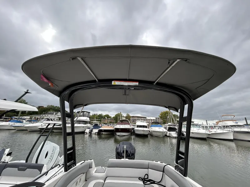 Slide: The Image of 2021 NauticStar 243 DC boat docked at marina under cloudy sky. - 26