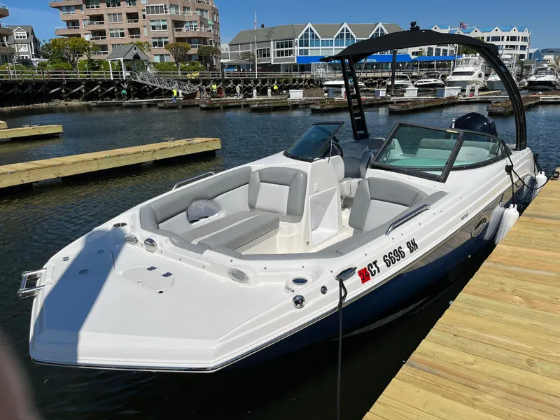 Slide: The Image of 2021 NauticStar 243DC Sport Deck boat on a sunny lake. - 2