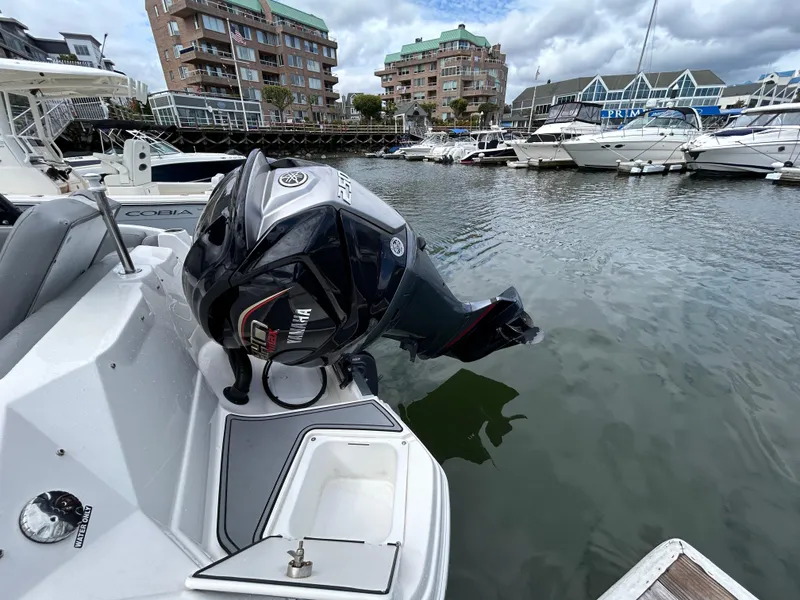 Slide: The Image of 2021 NauticStar 243DC Sport Deck boat with Yamaha outboard motor docked in marina. - 32
