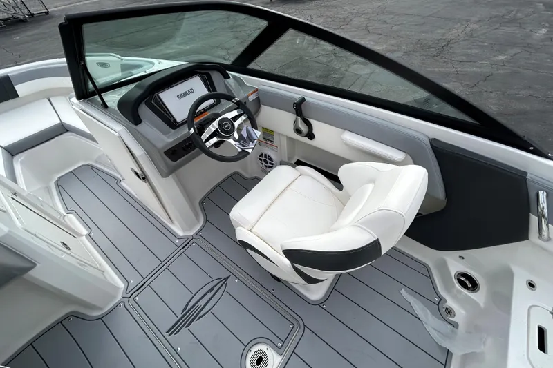Slide: The Image of 2026 Chaparral 21 SSi OB boat interior with modern helm and seating. - 7