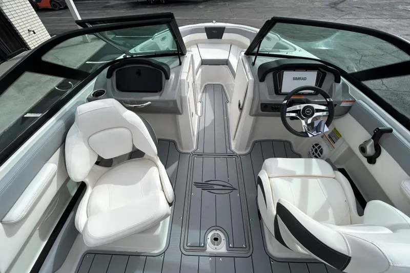 Slide: The Image of 2026 Chaparral 21 SSi OB boat interior with white seating and modern dashboard. - 9