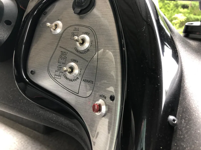 Slide: The Image of Control panel of 2021 Bass Tracker PRO TEAM 175 TXW boat with switches and labels. - 12