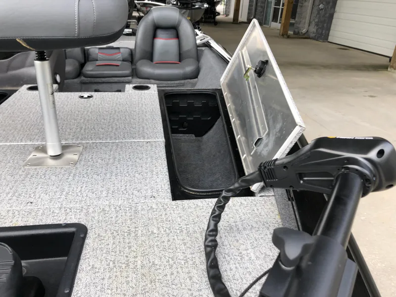 Slide: The Image of 2021 Bass Tracker PRO TEAM 175 TXW interior with open storage compartment and seating. - 16
