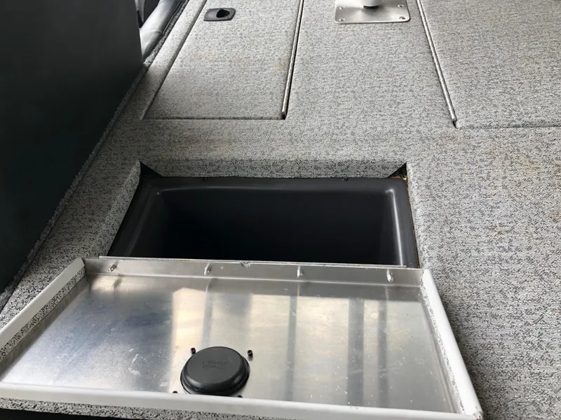 Slide: The Image of 2021 Bass Tracker PRO TEAM 175 TXW boat storage compartment with open lid. - 18