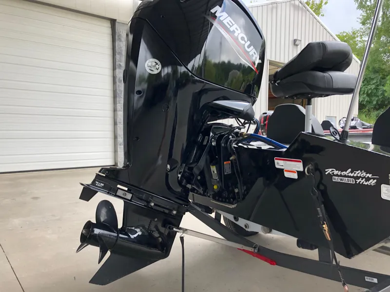 Slide: The Image of 2021 Bass Tracker PRO TEAM 175 TXW with Mercury outboard motor, parked near a garage. - 19