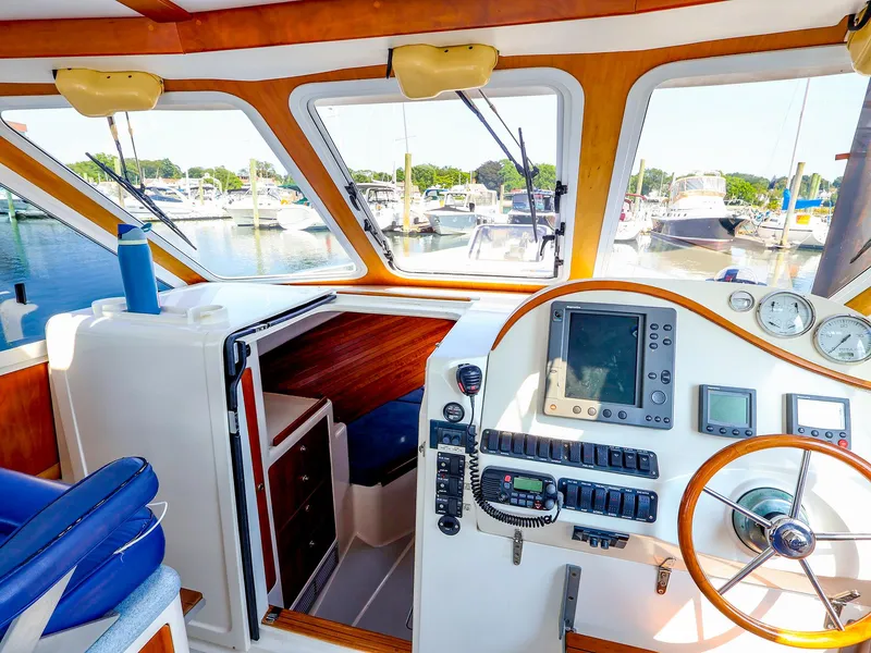 Slide: The Image of Interior of 2004 True North 38 boat with navigation equipment and marina view. - 11