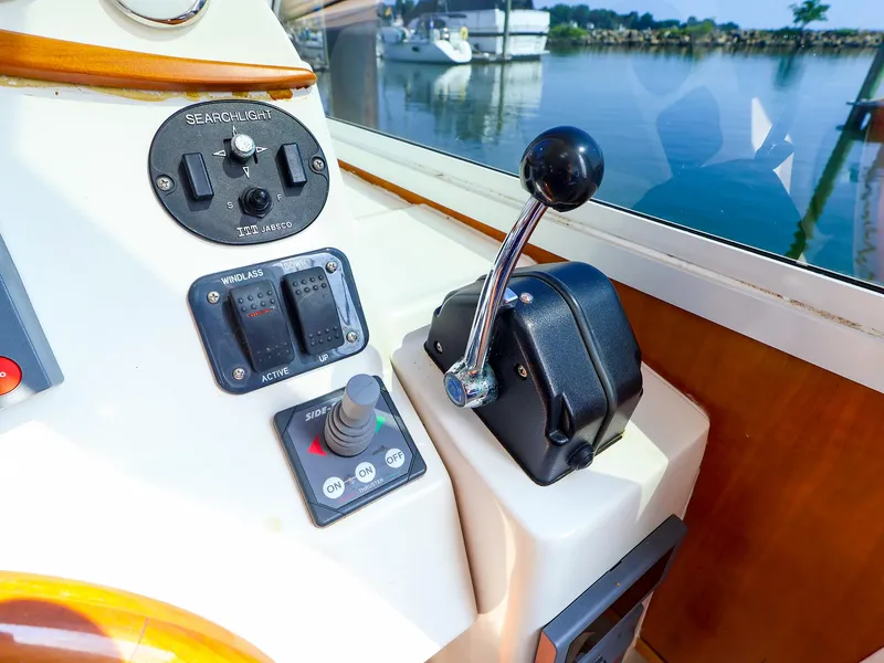 Slide: The Image of Control panel of a 2004 True North 38 boat with throttle and switches. - 16