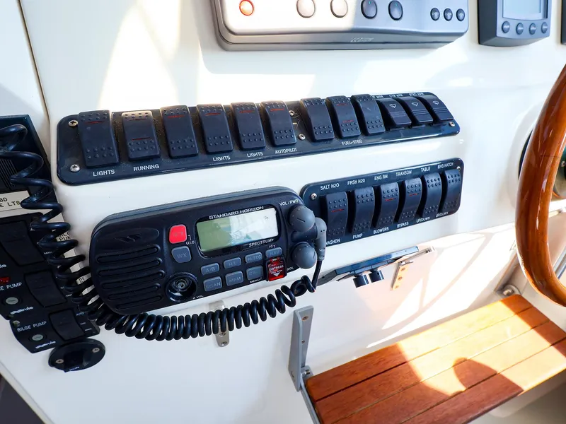 Slide: The Image of Control panel of a 2004 True North 38 boat with radio and switches. - 19