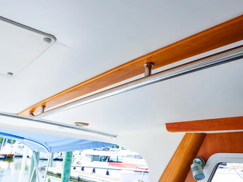Slide: The Image of Interior view of 2004 True North 38 boat with wooden and metal ceiling details. - 2
