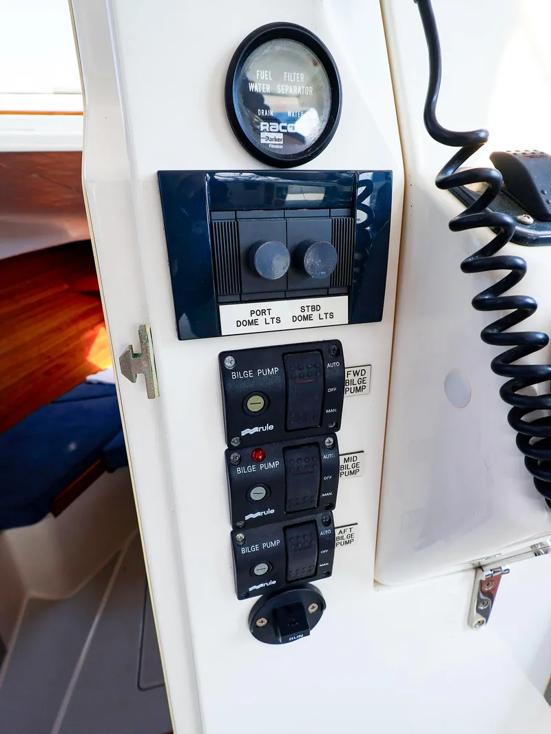 Slide: The Image of Control panel on a 2004 True North 38 boat, featuring bilge pump switches. - 21