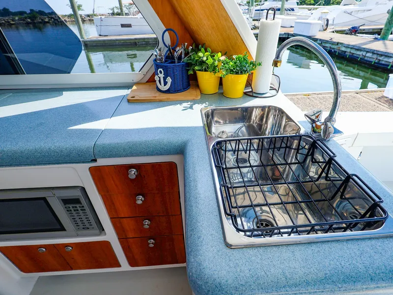 Slide: The Image of Modern yacht kitchen with sink, microwave, and potted plants on True North 38, 2004 model. - 29