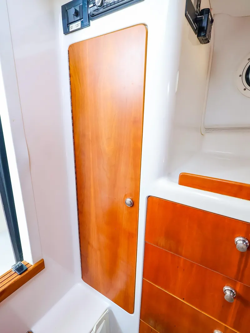 Slide: The Image of Wooden cabinet and drawers inside a 2004 True North 38 boat interior. - 36