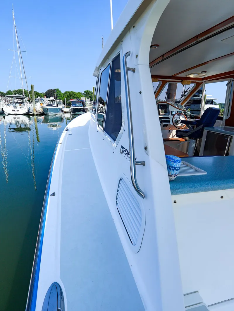 Slide: The Image of 2004 True North 38 boat docked at marina, interior view of helm and seating. - 4