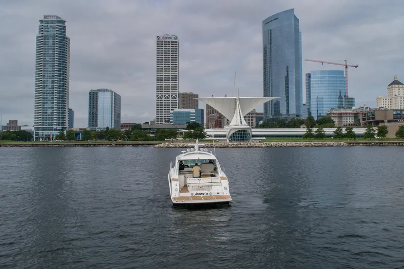 Slide: The Image of Sea Ray 470 Sundancer yacht on water with city skyline in background, 2009 model. - 10