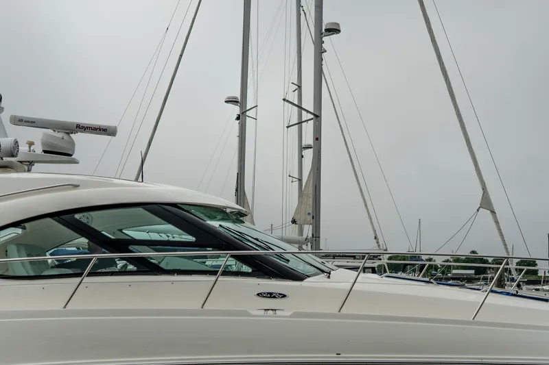 Slide: The Image of 2009 Sea Ray 470 Sundancer yacht with radar, docked under overcast sky. - 13